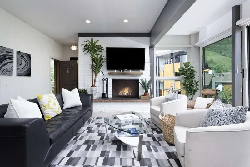 Relax and by the wood burning fire at the end of the ski day and enjoy the amazing views from this light filled living room with floor to ceiling wind